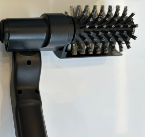 Velorian Collection electric BBQ grille brush cleaning heavy grease from grill grates with sturdy bristles and ergonomic handle.