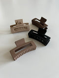 BaseLayer hair claws, stylish and practical hair accessories, shown holding hair in a secure and fashionable style.
