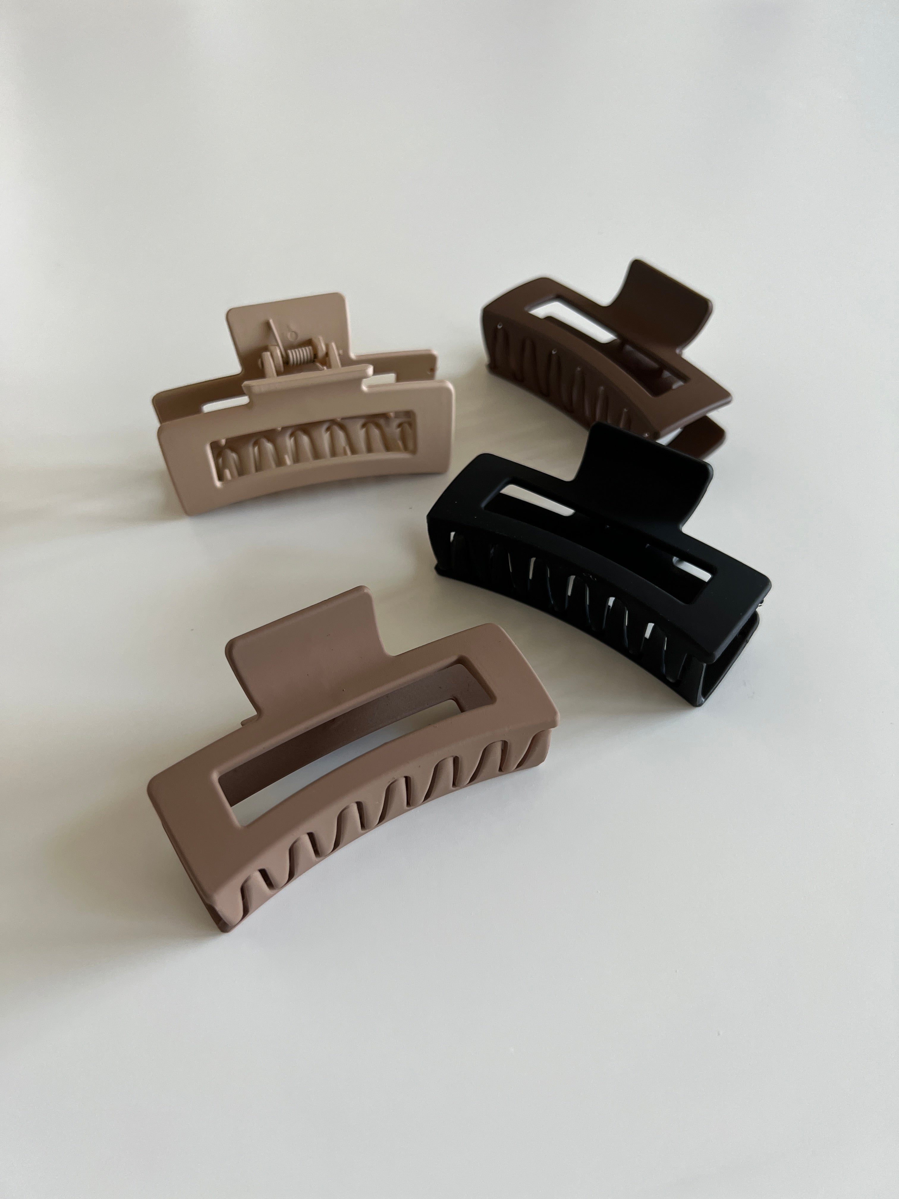 BaseLayer hair claws, stylish and practical hair accessories, shown holding hair in a secure and fashionable style.