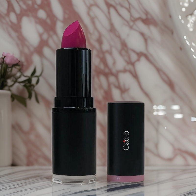 Pink Pizzazz lipstick by Cad b with beeswax for hydration, cruelty-free and paraben-free, shown in a sleek tube.