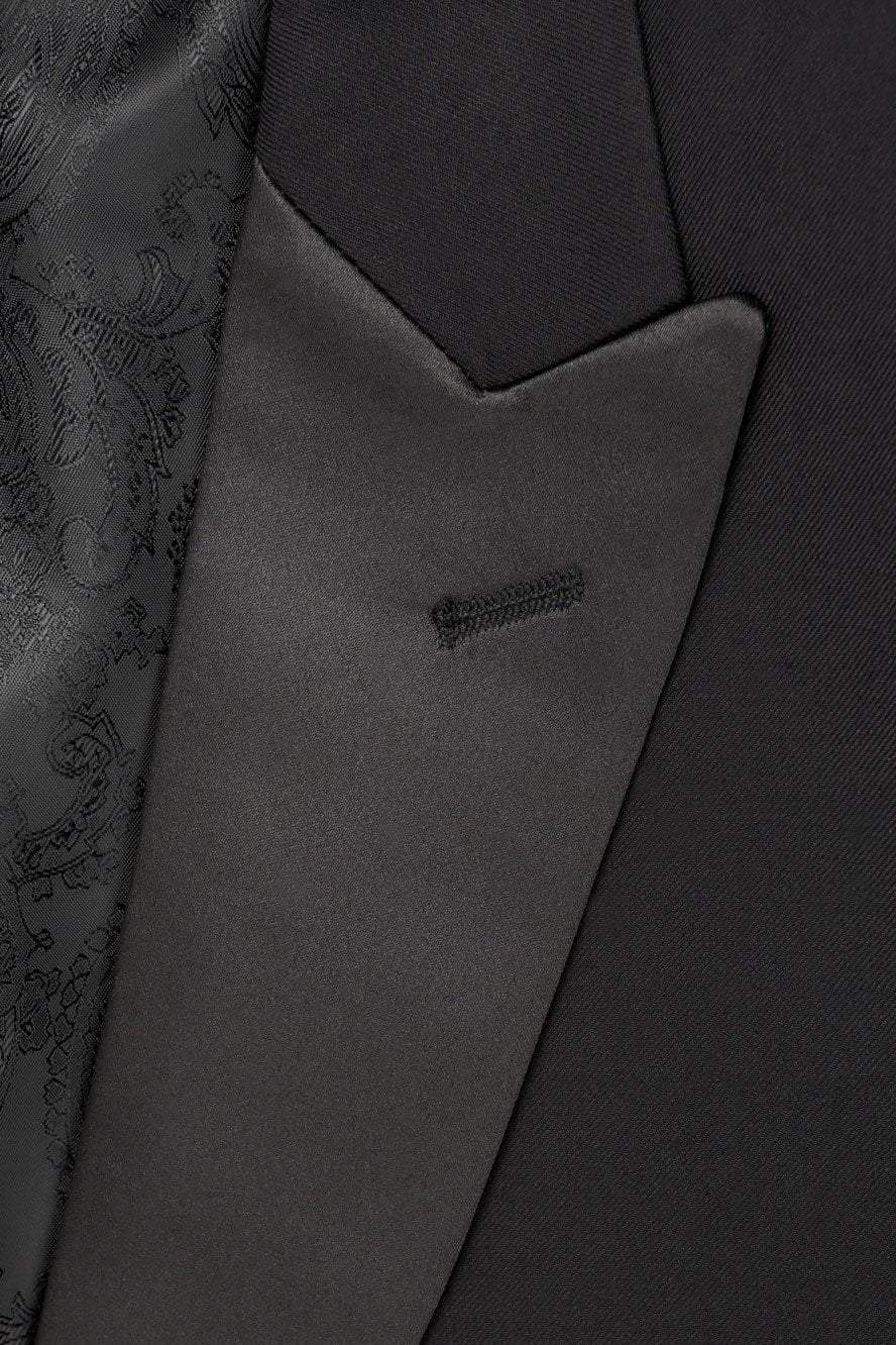 Black Milan Tuxedo Jacket by Tux-USA featuring peak lapels, tailored fit, suitable for formal occasions, shown on a hanger.